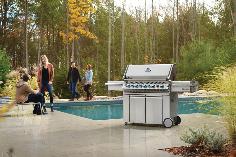 Napoleon Prestige Pro 665 gas grill on a patio by the pool